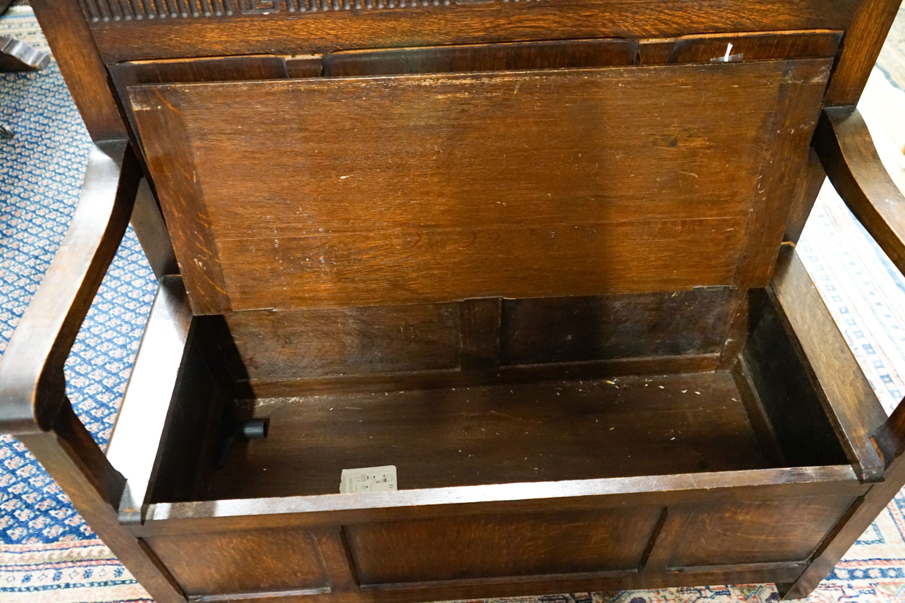 A 1920's rectangular bevelled wall mirror in oak frame, width 53cm, height 74cm together with a late Victorian wall-mounted medicine cabinet and an 18th century style panelled oak box seat settle, width 108cm, depth 45cm